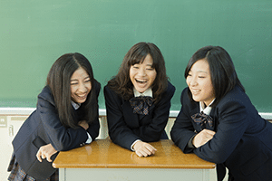 Three Asian students laughing