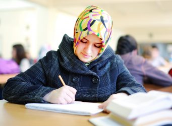 Muslim girl studying in library