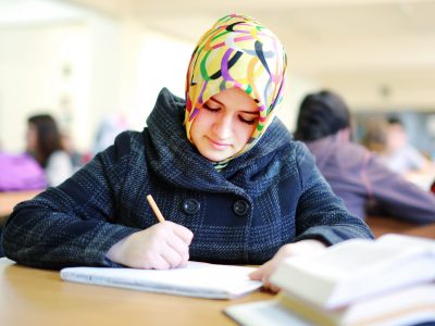 Muslim girl studying in library